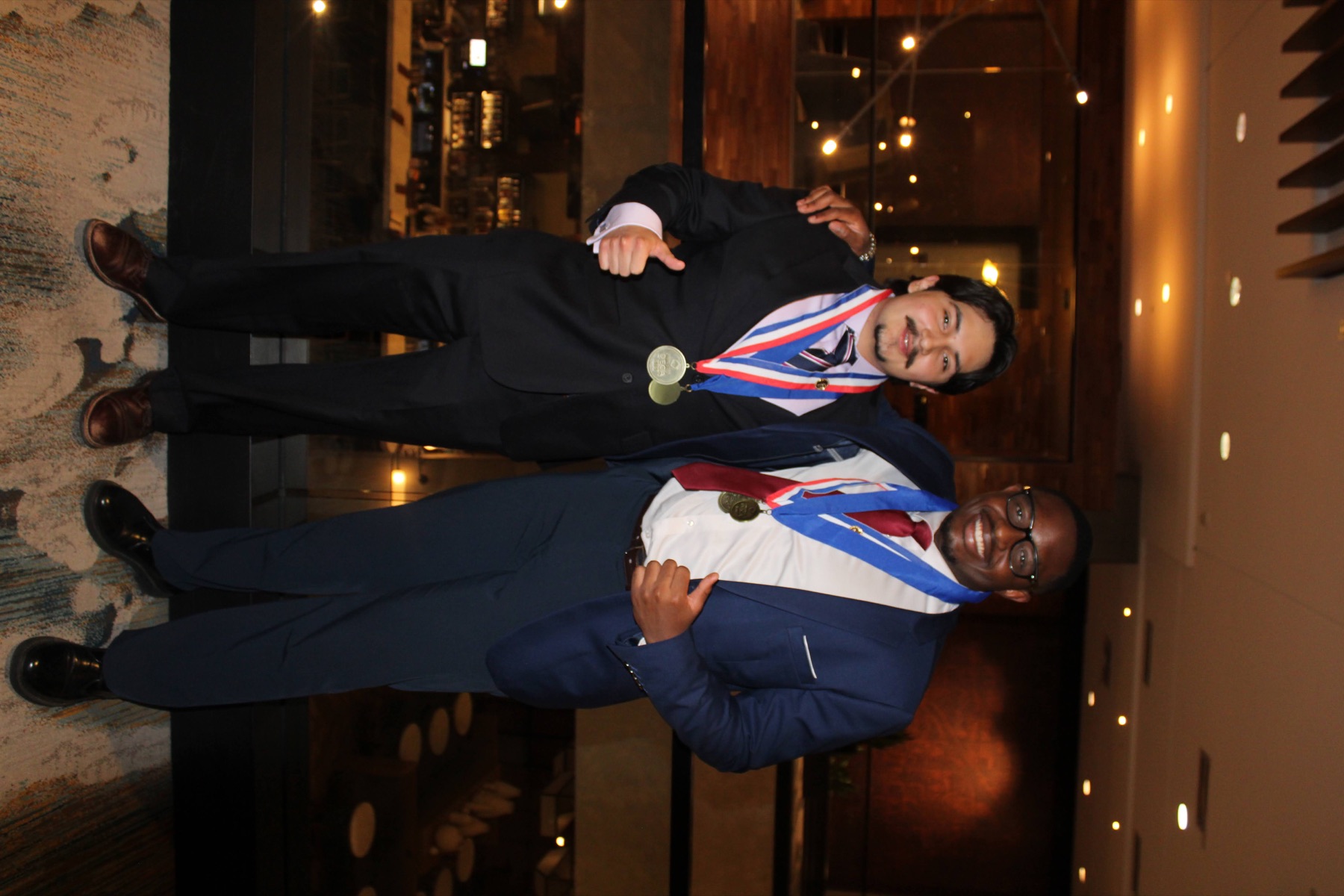 Two UNC Charlotte DECA medal winners celebrating