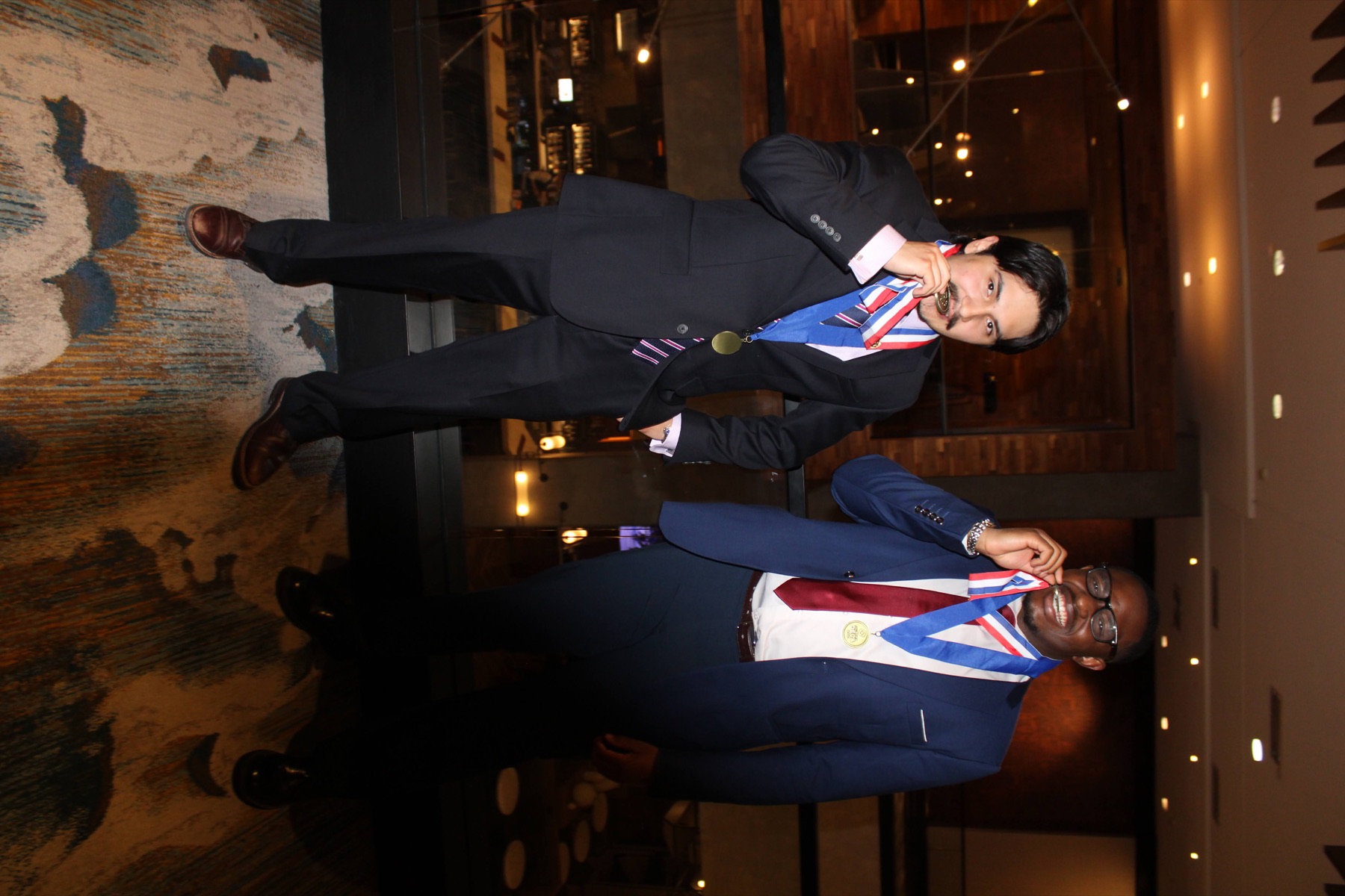 Two chapter members playfully celebrating their medals