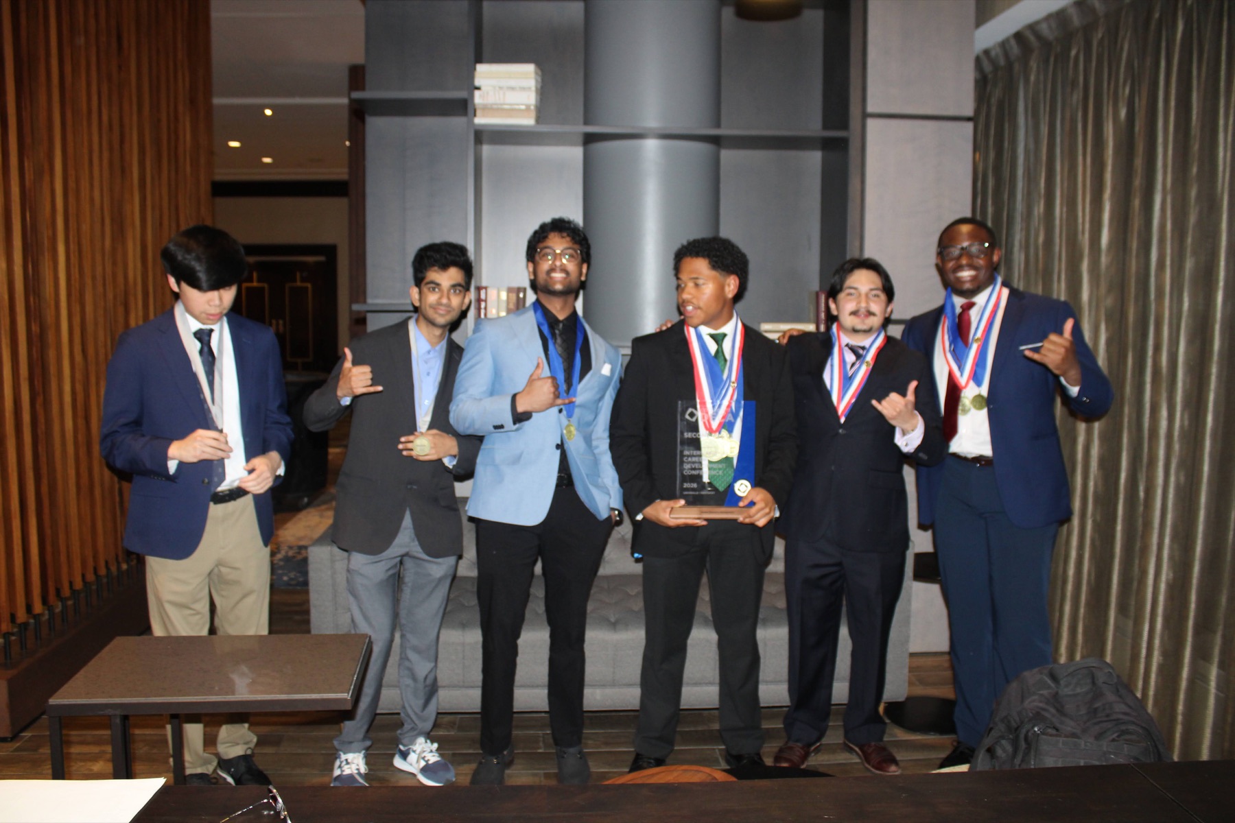 UNC Charlotte chapter celebrating with medals and trophy